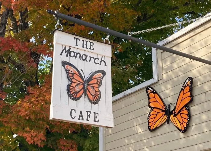 Hanging sign outside a restaurant called The Monarch Cafe